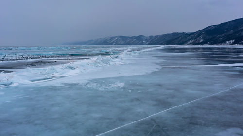 Scenic view of sea against sky during winter