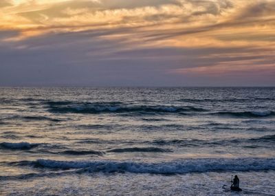 Scenic view of beach against sky during sunset