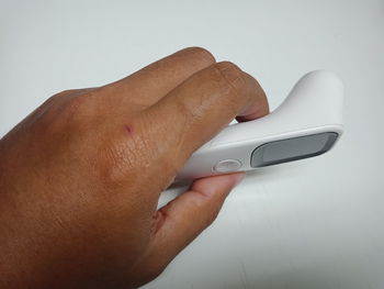 Close-up of human hand against white background