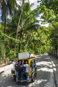 View of people sitting on road