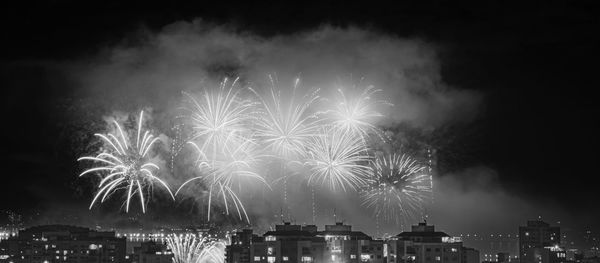 Low angle view of firework display at night