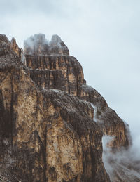 Rock formation on mountain against sky