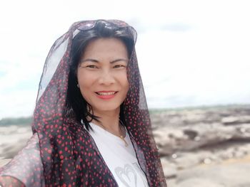 Portrait of smiling young woman on beach