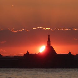 Silhouette of statue at sunset