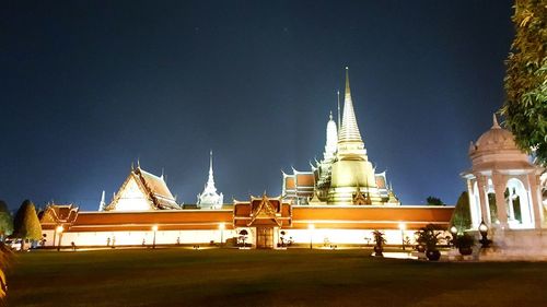 Illuminated temple against sky at night