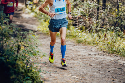 Male athlete runner run forest trail marathon