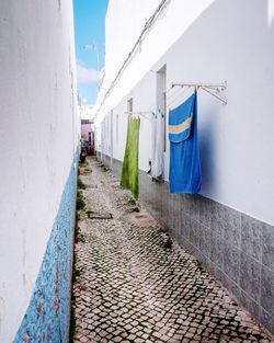 Clothes drying on footpath against building