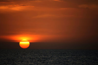 Scenic view of sea against romantic sky at sunset