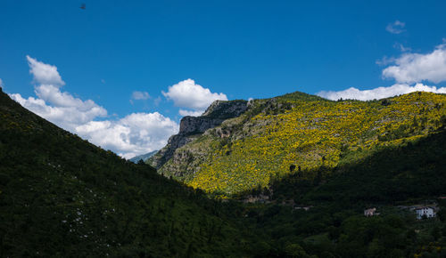 Scenic view of mountains against blue sky