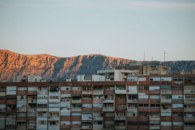 Buildings in city against clear sky