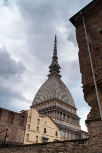 Low angle view of temple against cloudy sky