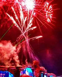 Low angle view of firework display at night