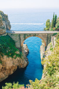 High angle view of arch bridge over sea against sky