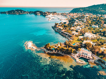 Aerial view of swimming pool by sea against sky