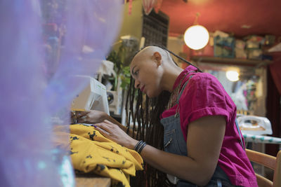 Portrait of stylish young female designer at work