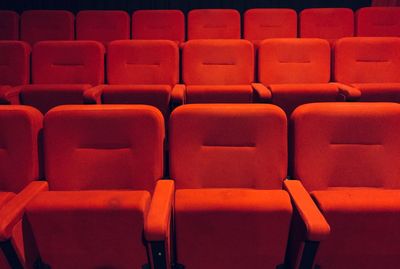 Full frame shot of red empty seats in auditorium