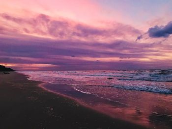 Scenic view of beach against sky during sunset