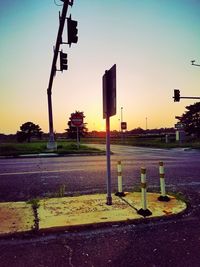 Road sign at sunset