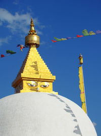 Buddhist stupa with ornaments against the clear blue sky