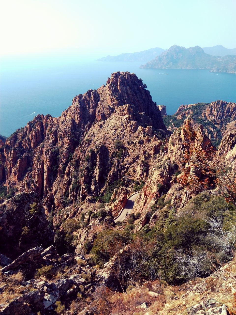 mountain, tranquil scene, sea, scenics, tranquility, water, rock formation, beauty in nature, rock - object, nature, cliff, rock, mountain range, landscape, clear sky, geology, sky, high angle view, idyllic, physical geography