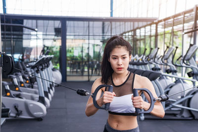 Young woman exercising in gym