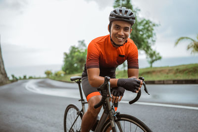 Man riding bicycle on road