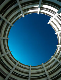 Low angle view of skylight against clear blue sky