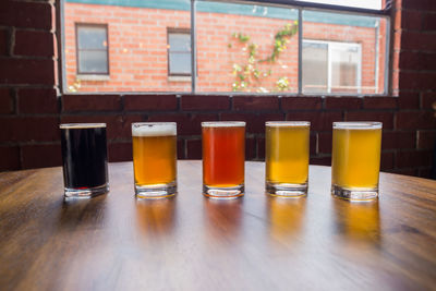 View of drinking glasses in row placed on table