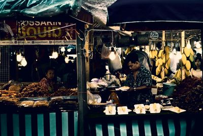 People for sale at market stall