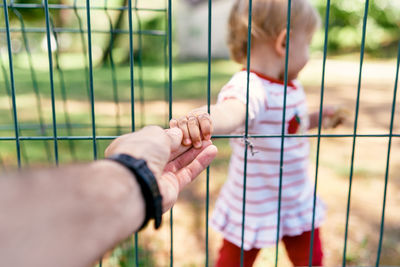 Cute girl holding fathers hand