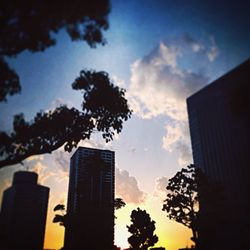 Low angle view of buildings against cloudy sky