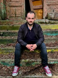 Portrait of young man sitting outdoors