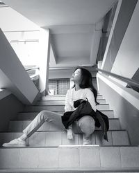 Low angle view of woman sitting on steps