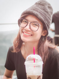 Close-up portrait of young woman wearing glasses