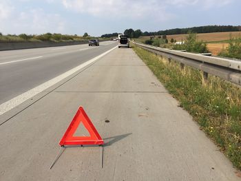 Close-up of hazard sign on roadside