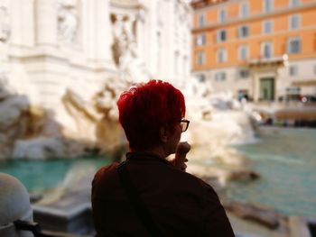 Rear view of man standing at trevi fountain 