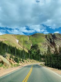 Road amidst trees against sky