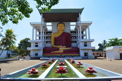 Low angle view of people walking on street
