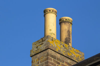 Low angle view of smoke stack against sky