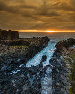 Scenic view of sea against cloudy sky