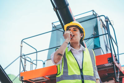 Low angle view of boy working at construction site