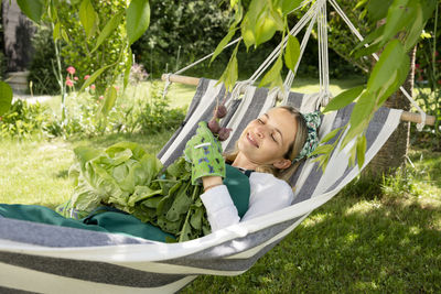 Portrait of young woman sitting on grass