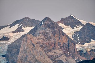 Scenic view of mountains against clear sky during winter