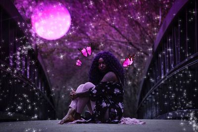 Portrait of woman looking at pink flower tree