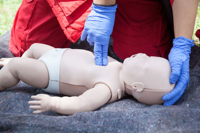 Volunteer giving first aid training with mannequin