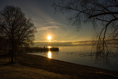 Scenic view of lake against sky during sunset