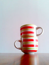 Close-up of cups on table against white background