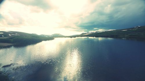 Scenic view of lake against cloudy sky