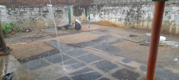 High angle view of wet street by buildings