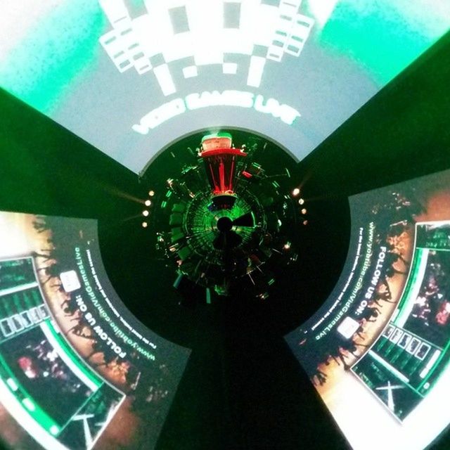 indoors, communication, technology, high angle view, text, close-up, ceiling, time, no people, green color, connection, modern, number, illuminated, western script, lighting equipment, spiral, reflection, architecture, glass - material